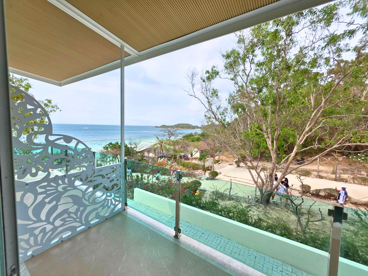 Serene tropical view with ocean glimpses from the Tropical Escape Room at Ta Yai Beach Resort, Koh Larn